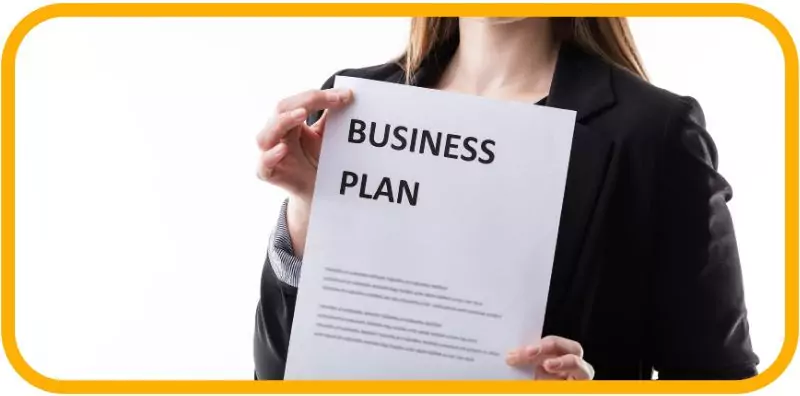  professional holding a document titled "Business Plan.